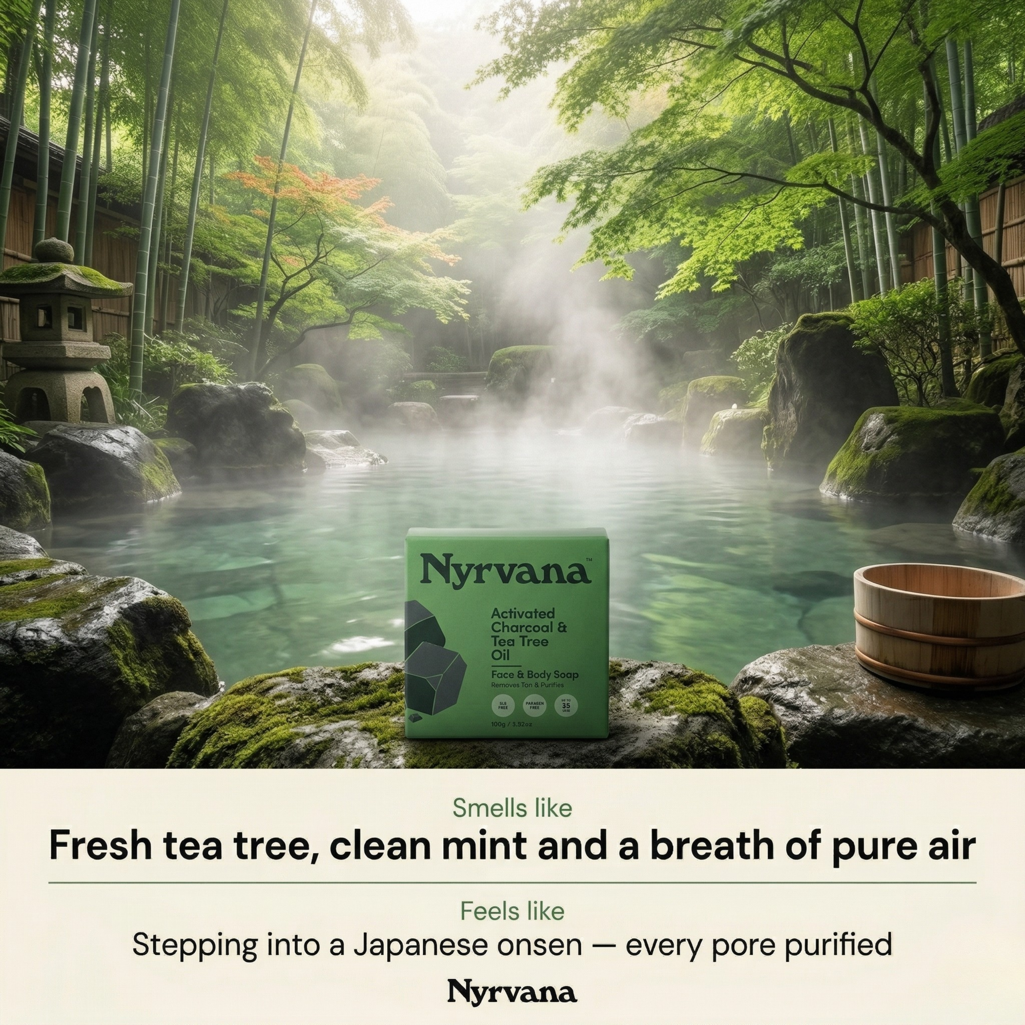 Nyrvana Activated Charcoal Tea Tree Soap box on mossy rocks beside misty Japanese onsen pool surrounded by bamboo forest