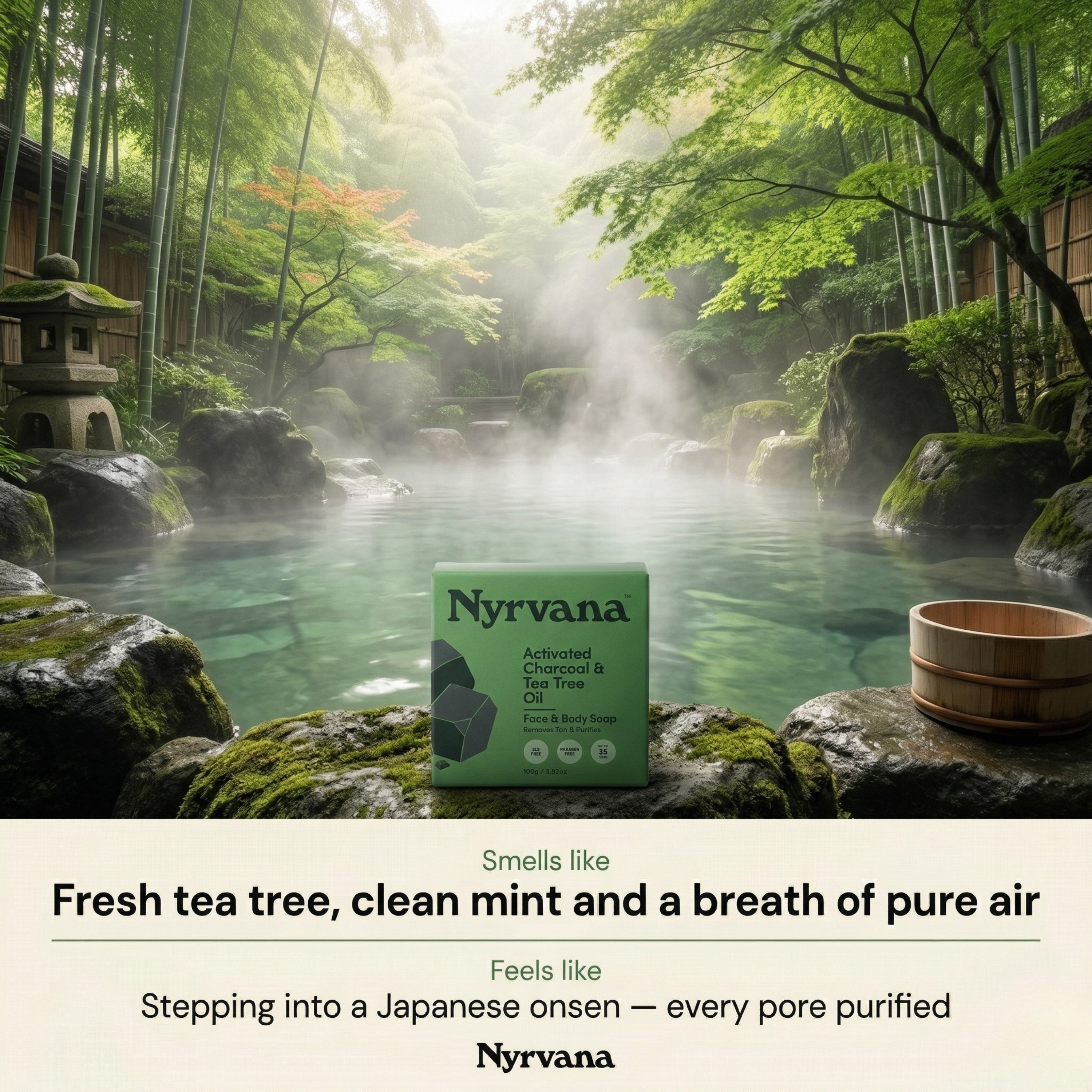 Nyrvana Activated Charcoal Tea Tree Soap box on mossy rocks beside misty Japanese onsen pool surrounded by bamboo forest