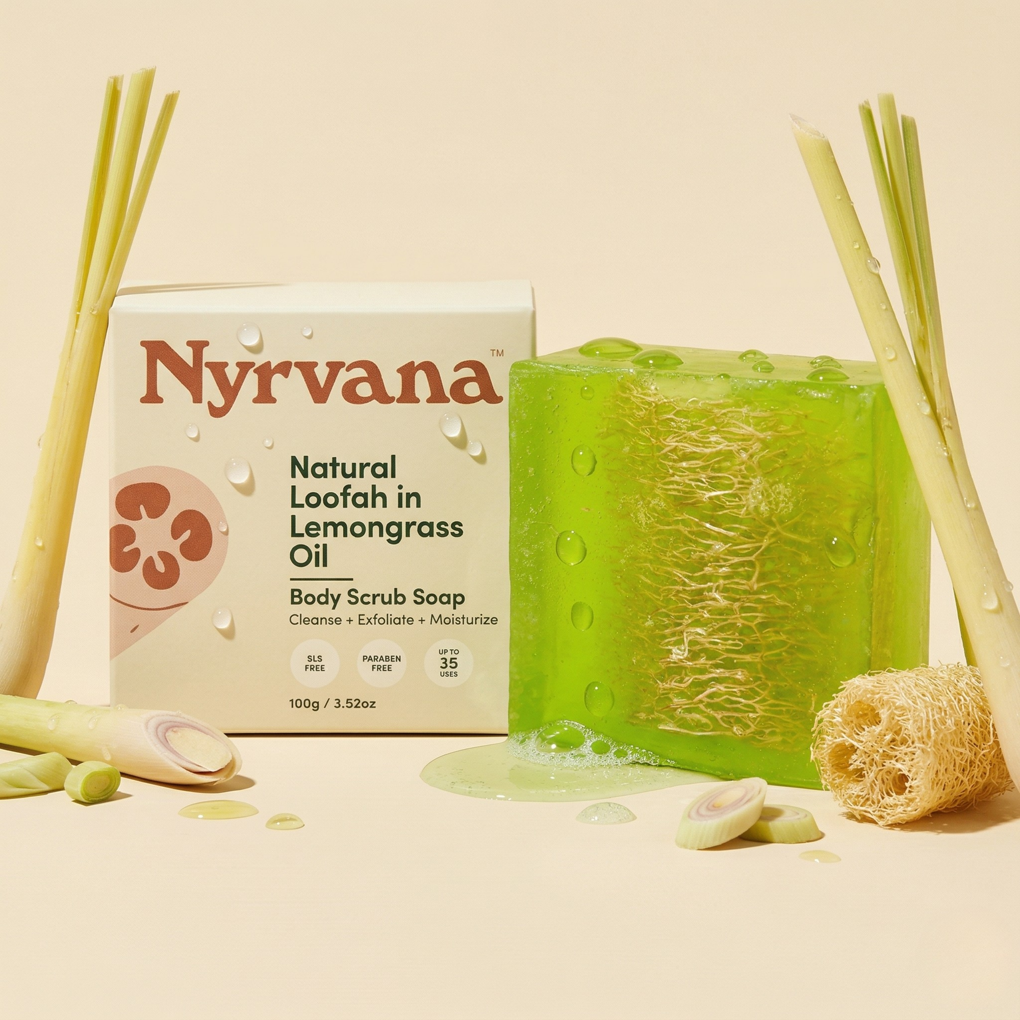 Nyrvana Loofah Lemongrass Scrub Soap 100g with box surrounded by fresh lemongrass stalks and natural loofah sponge on cream background with water droplets