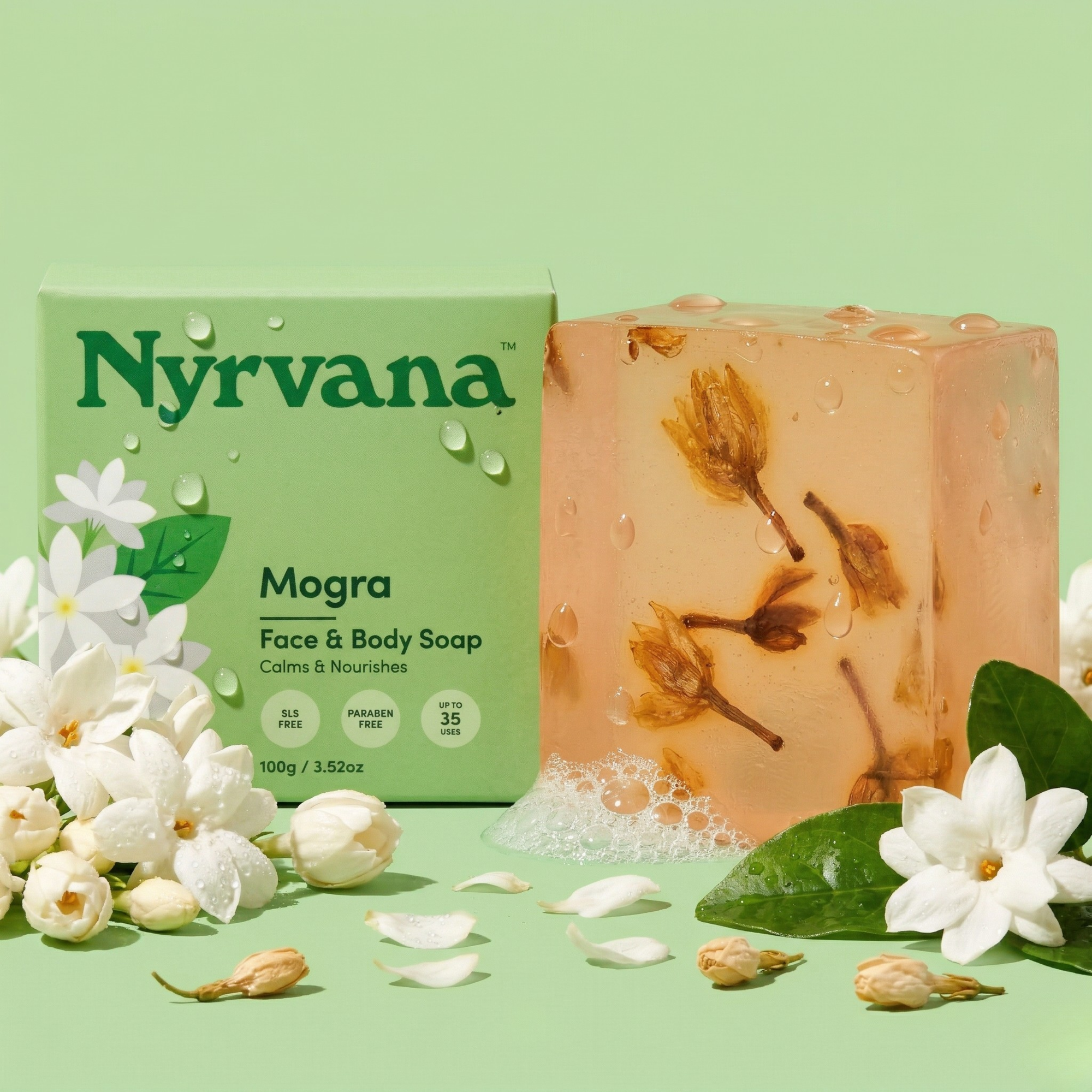 Nyrvana Mogra Soap 100g with box surrounded by fresh white mogra jasmine flowers and green leaves on green background with water droplets