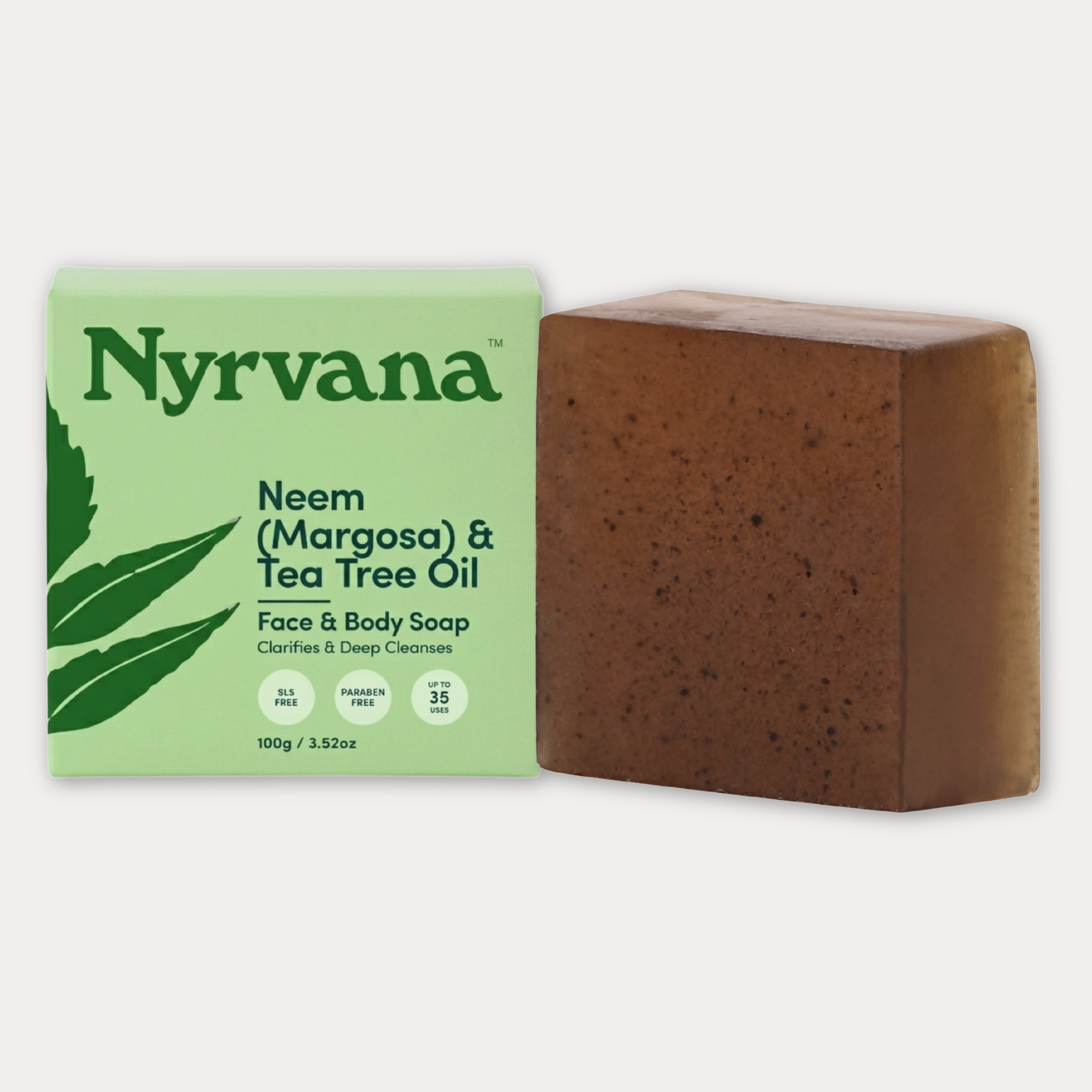 Nyrvana Neem Margosa and Tea Tree Oil Face and Body Soap 100g with light green box and dark brown speckled bar on white background