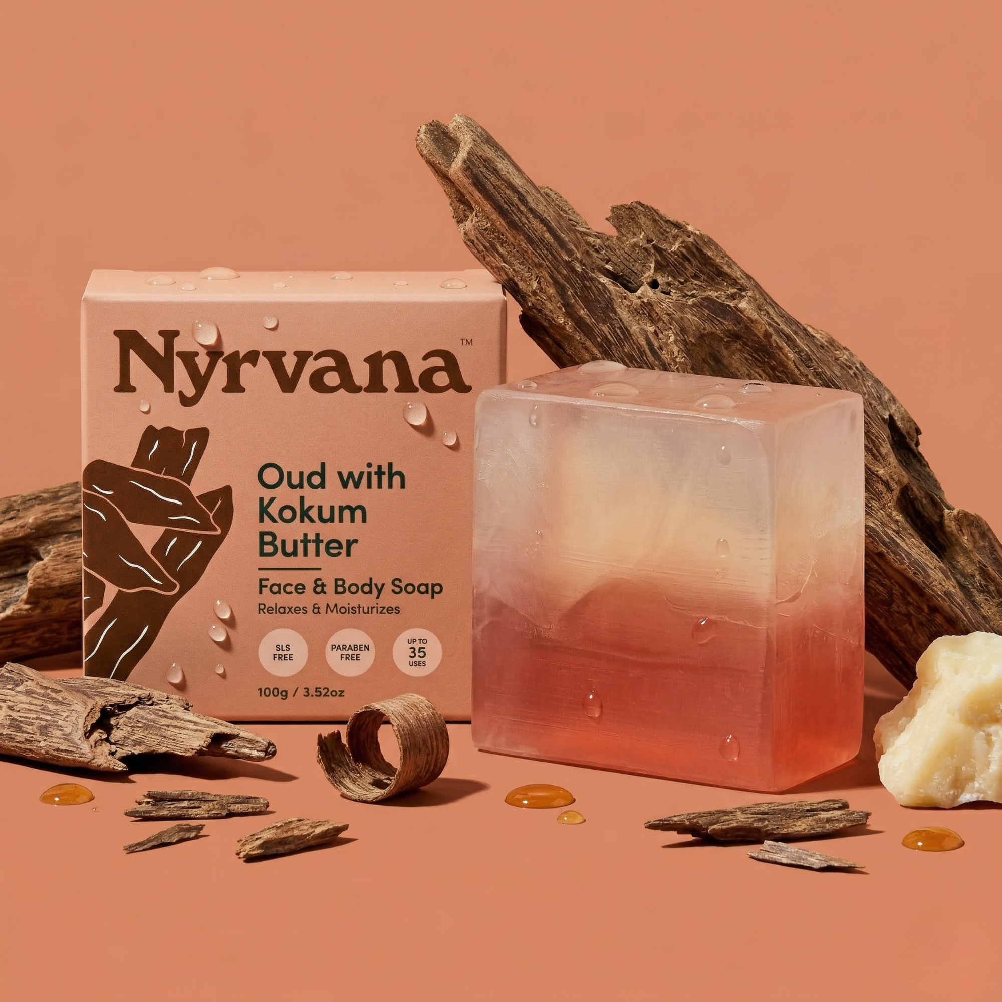 Nyrvana Oud Kokum Butter Soap 100g with box surrounded by oud wood chunks kokum butter and oil drops on terracotta background